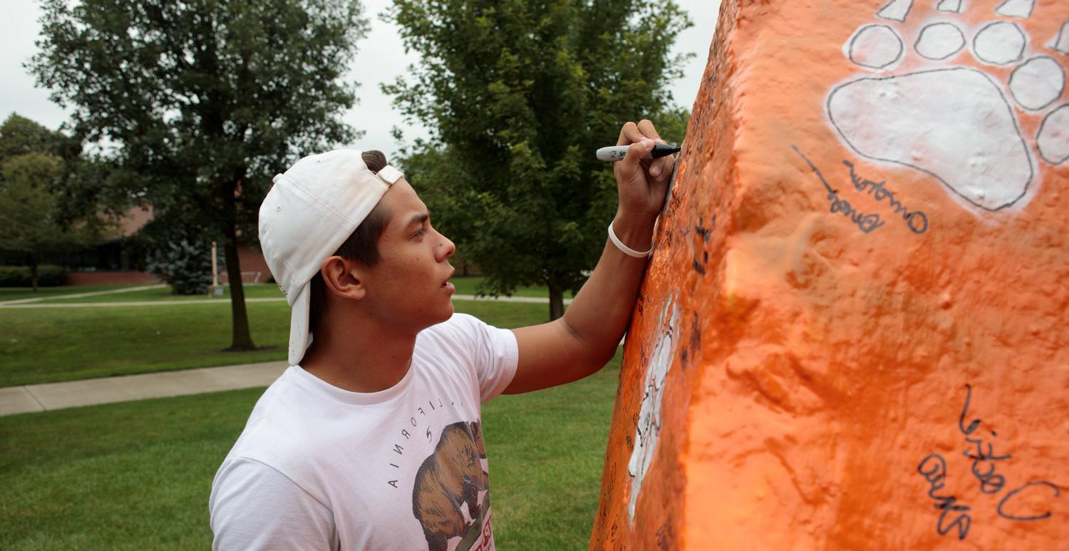 New student signing the spirit rock during welcome weekend.