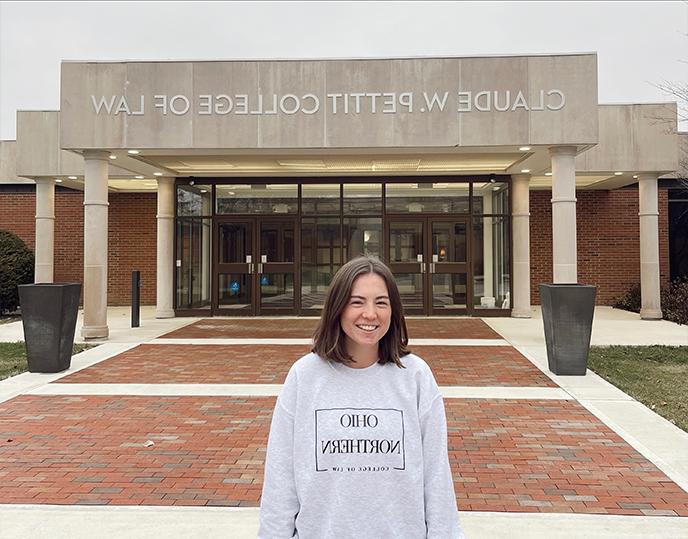Photo of Andrea Hoffman in front of Law Building